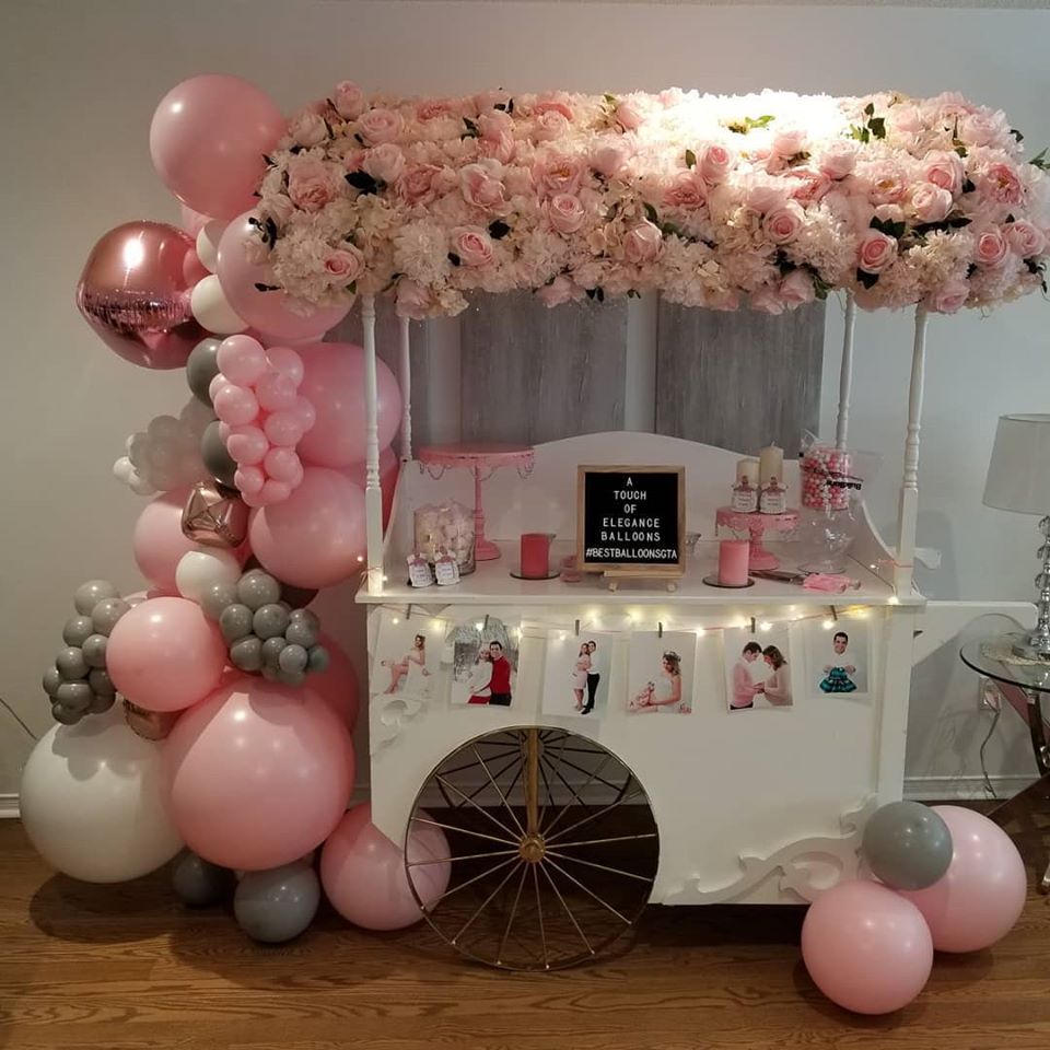 gray pink and white balloon garland on dessert cart