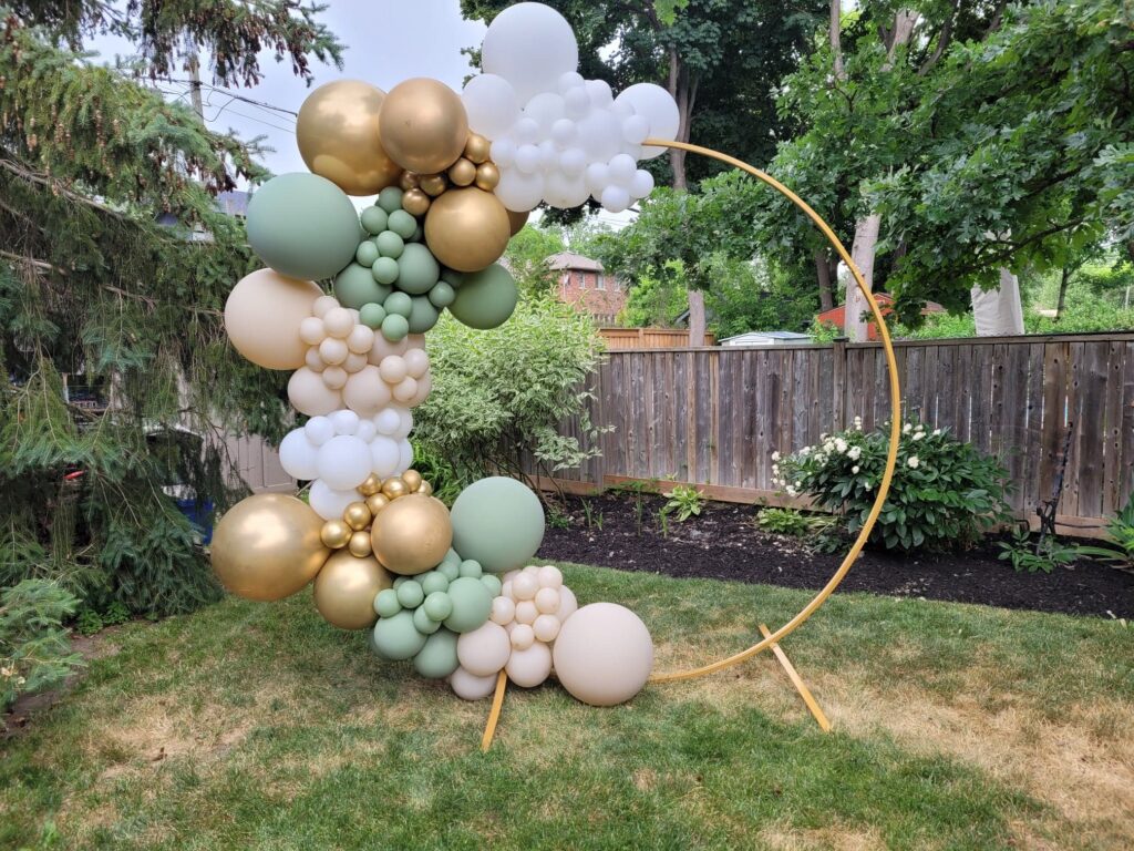 Earth tone balloon garland on gold ring prop
