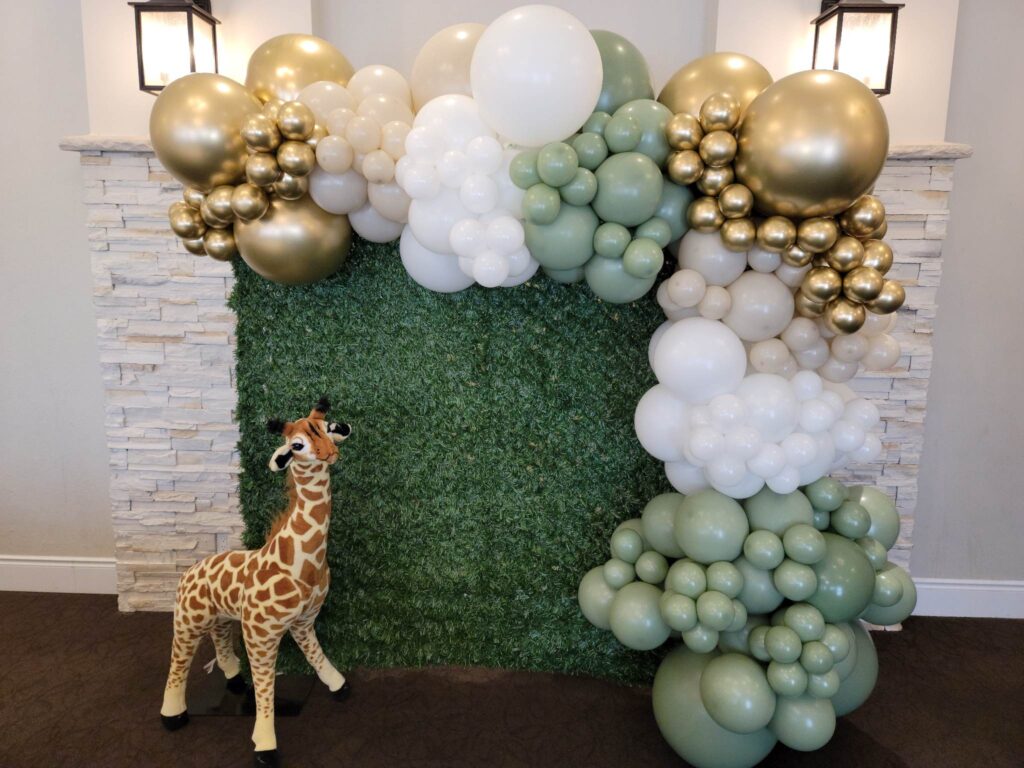 safari theme balloon garland sage green gold white nude balloons green grass backdrop giraffe